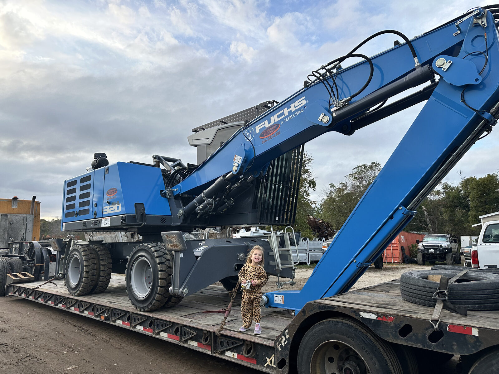 A Kastner family grandchild with the new material handler at the yard