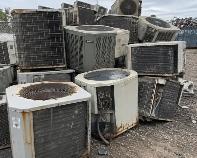 Old A/C condensers at a John's Famous yard